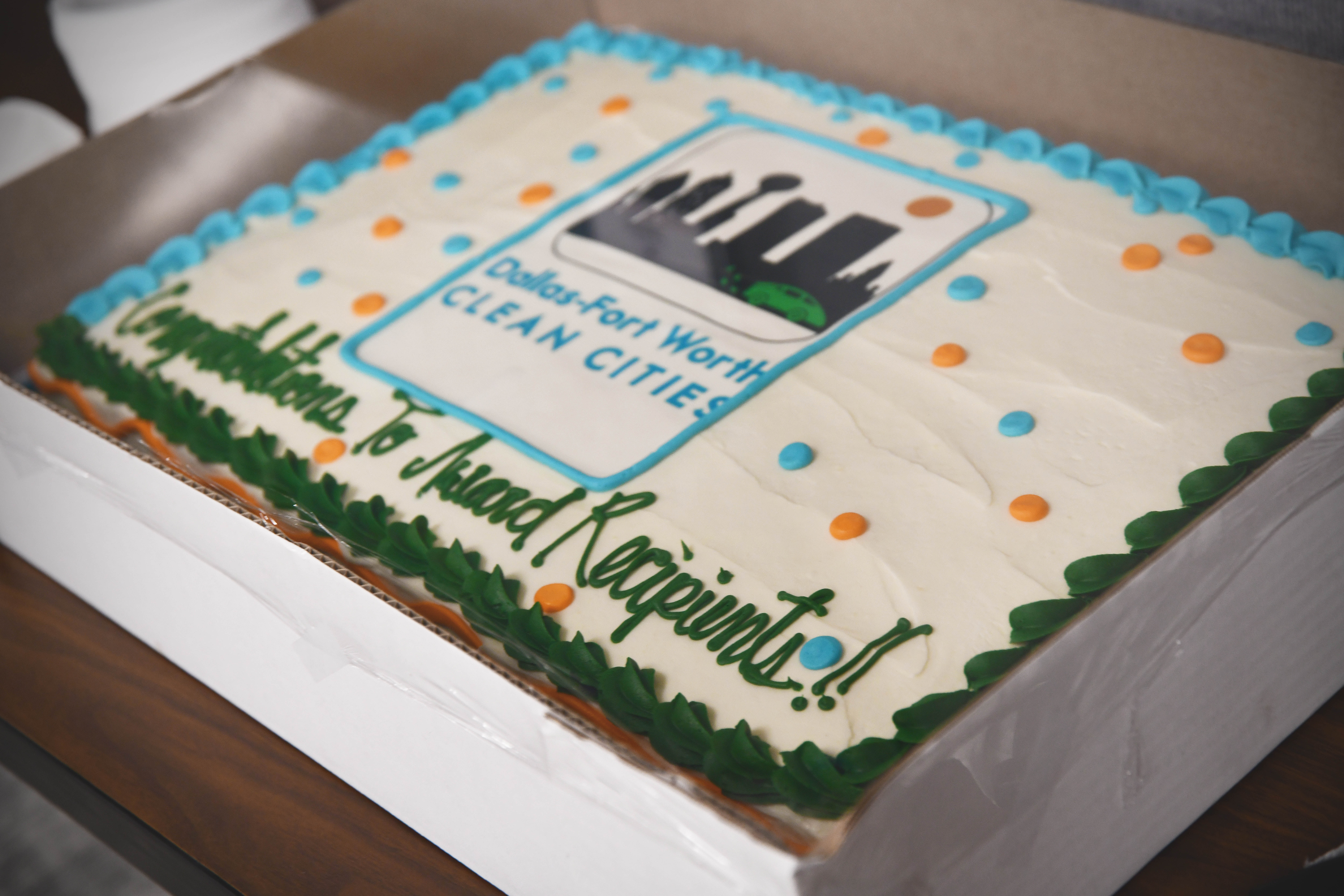 A cake with the Dallas-Fort Worth Clean Cities logo and the text "Congratulations to Award Recipients!"